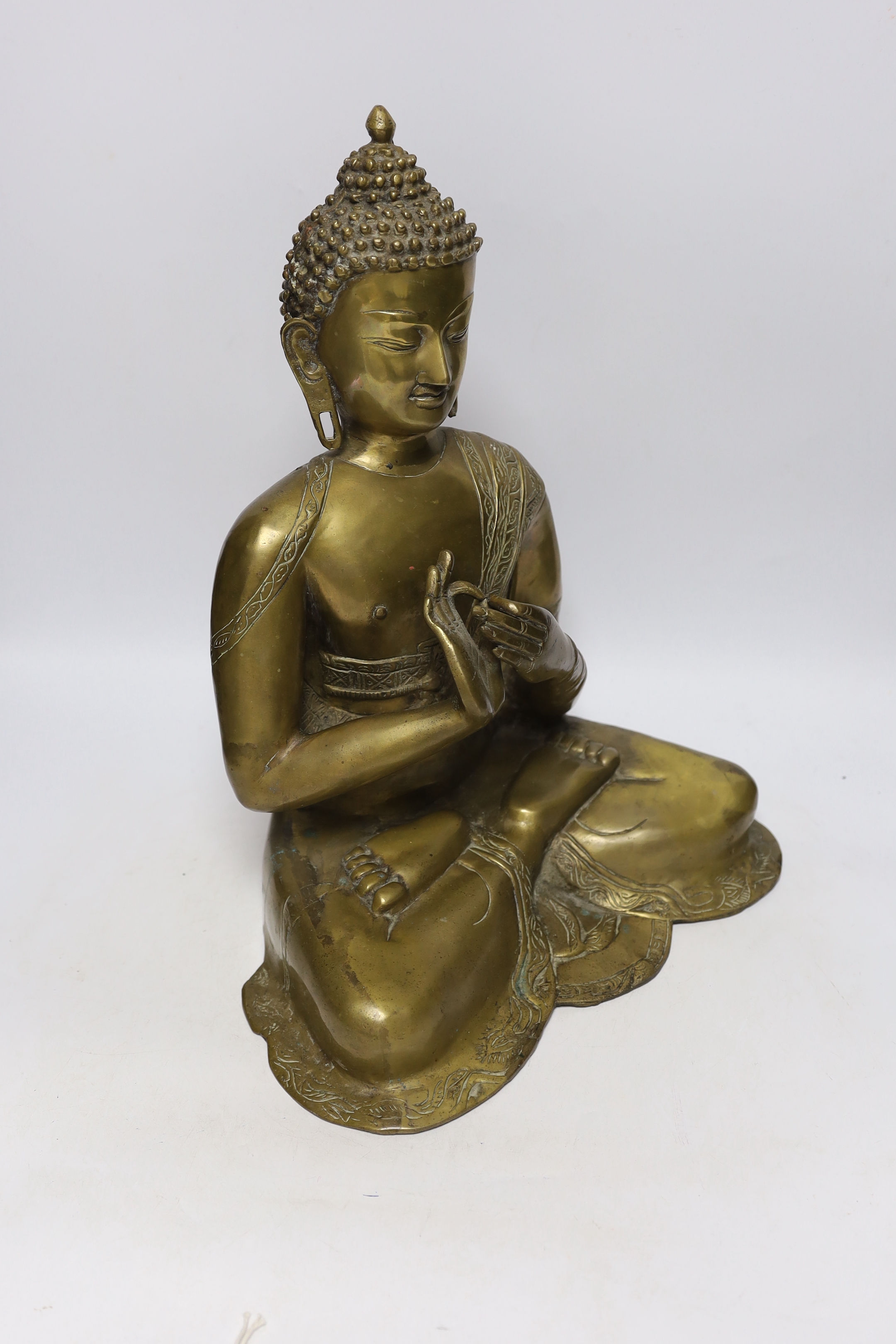 A Chinese or South East Asian bronze figure of seated buddha, 42cm high